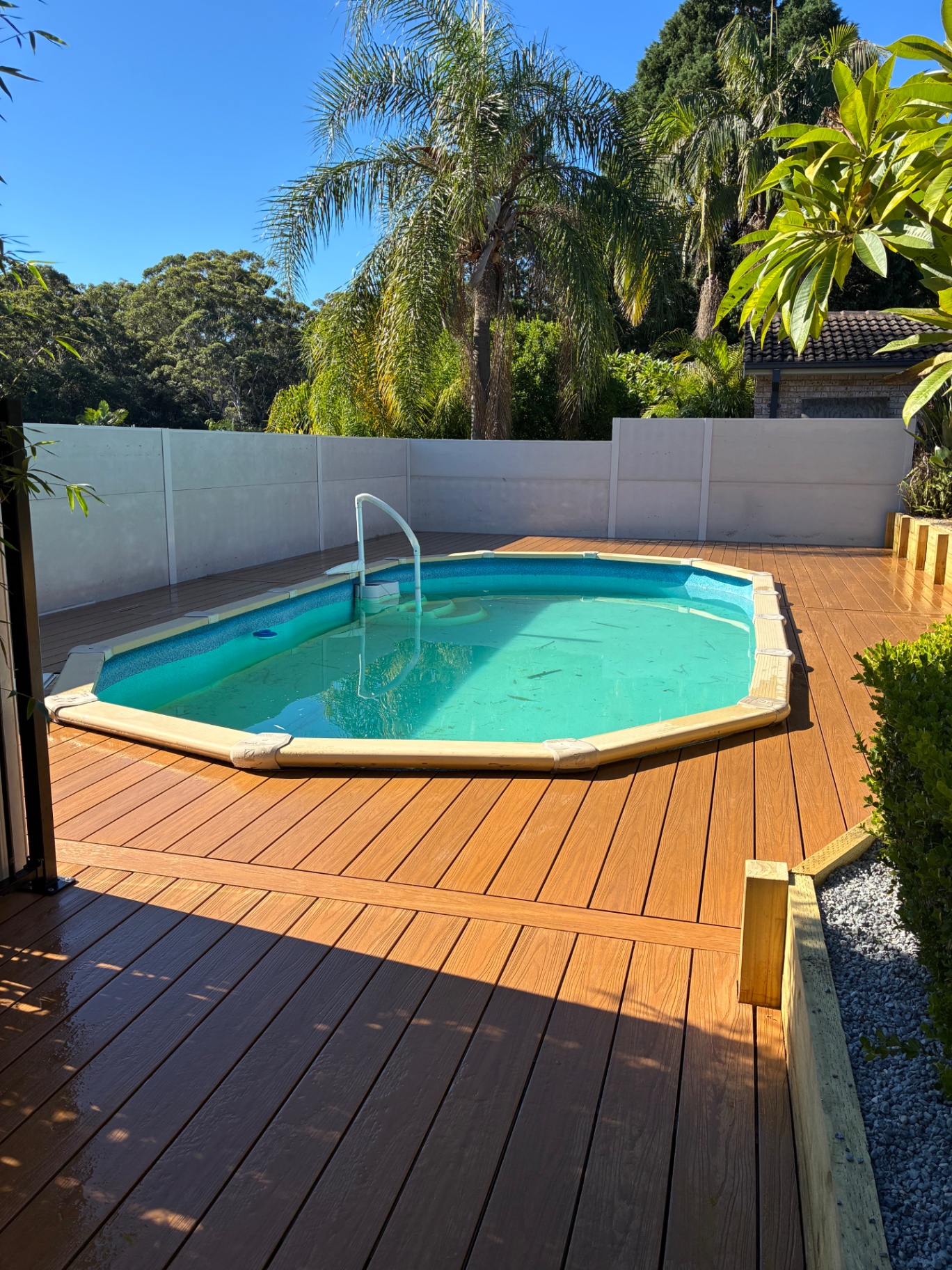 Wide view of the finished Ekodeck poolside deck at Green Point with the pool centred in the yard