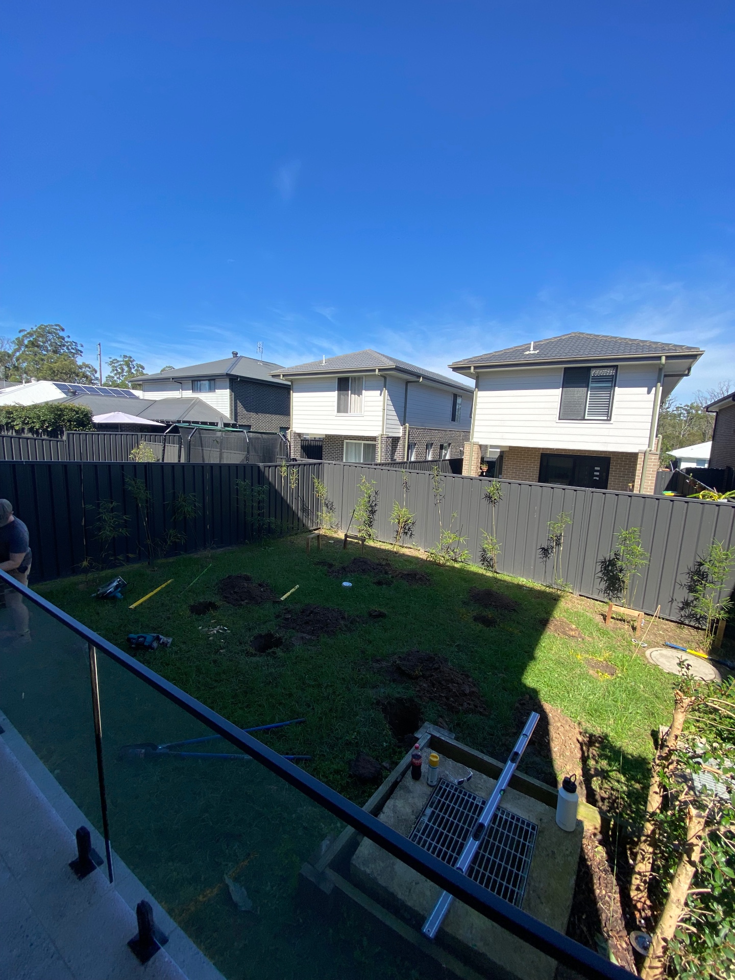 Before: sloping lawn with footing holes dug out in the Warnervale backyard prior to the deck build