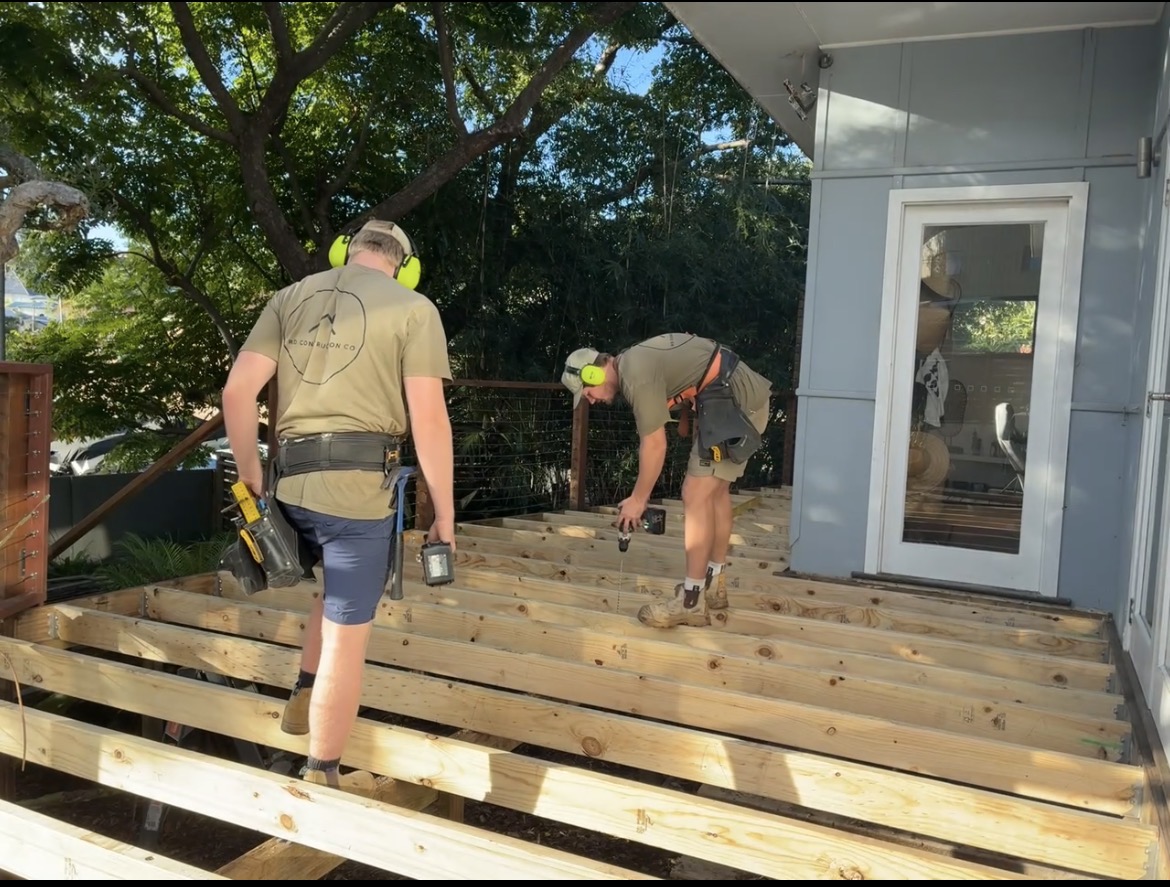 RD Construction Co carpenters fixing bearers and joists on a new hardwood deck frame