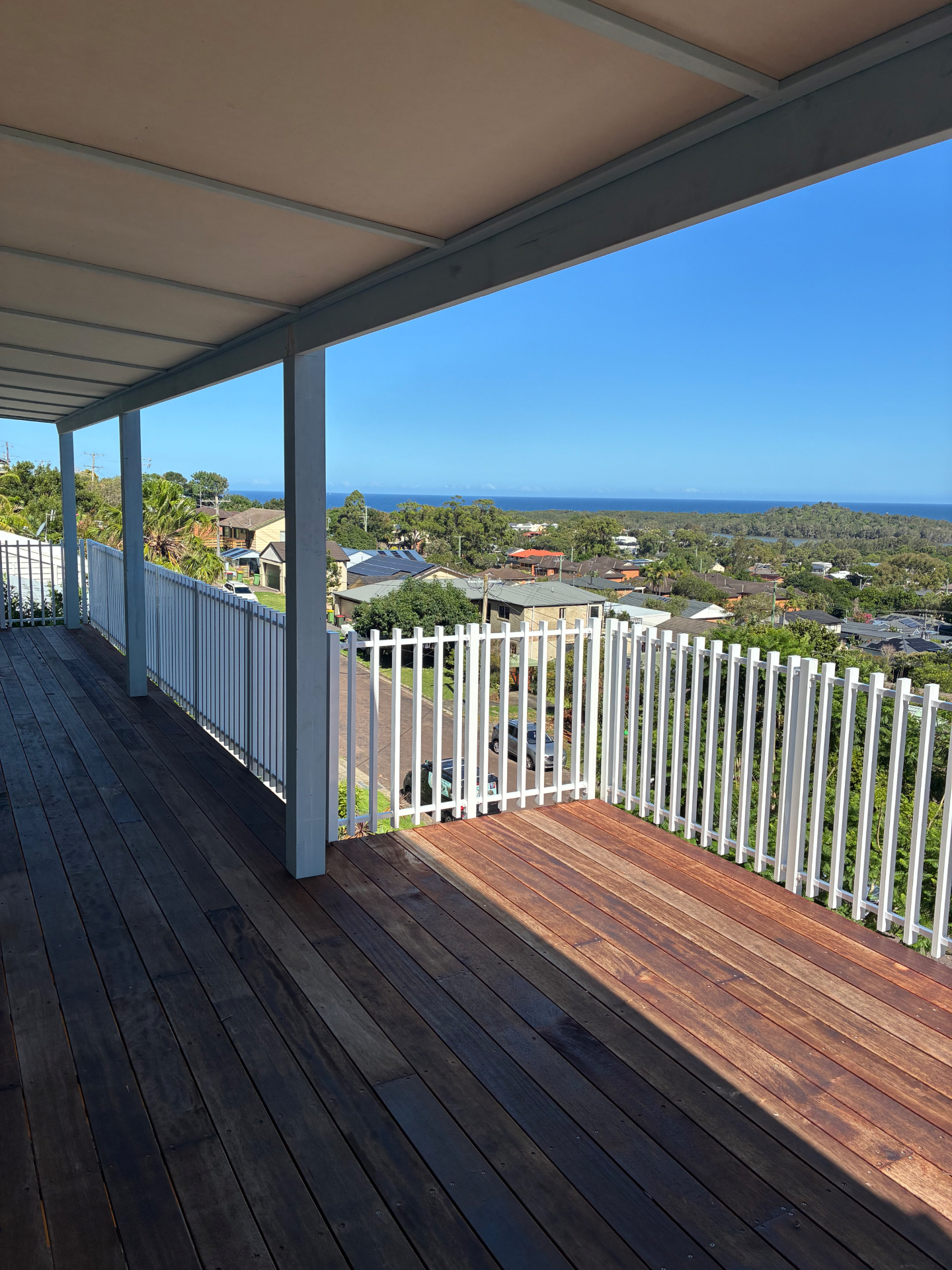 Merbau deck under the new pergola at Wamberal looking out over rooftops to the ocean
